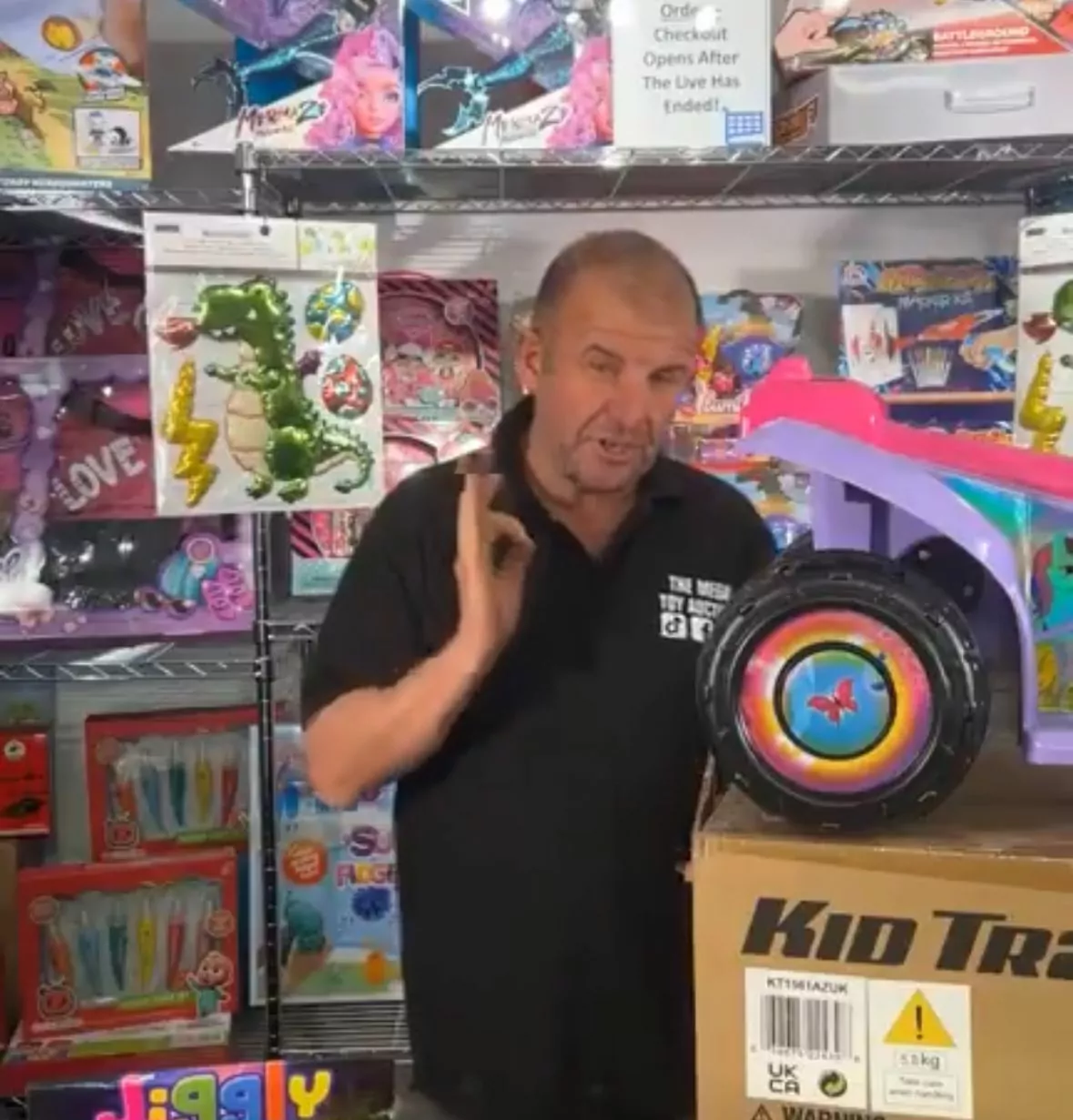 Justin demonstrating some of the braded bargain toys on sale